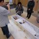Illustration for article titled In Japan, Living People Are Lying in Coffins
